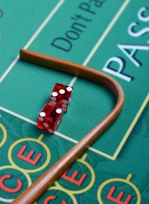 Dice and stick on craps table