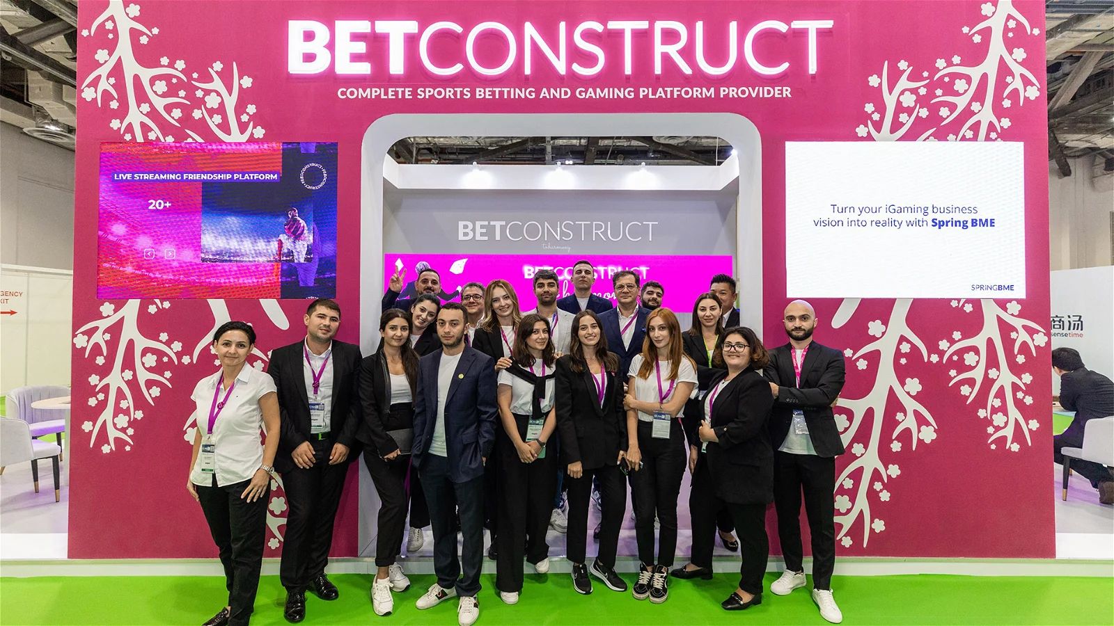 BetConstruct employees pose in front of a company booth at G2E